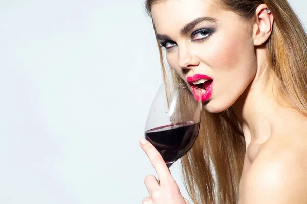 Pretty girl with red lips drinking wine from glass — Stock Photo, Image