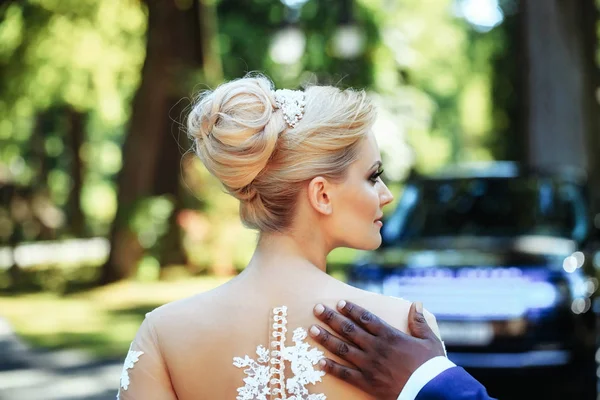 Pretty girl or cute bride with hand of african male — Stock Photo, Image