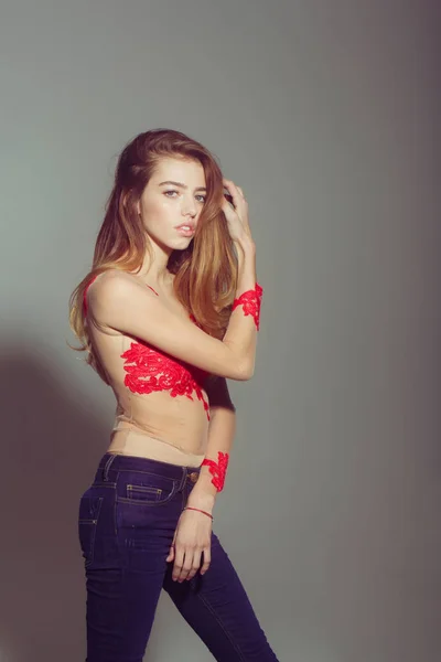 Pretty sexy woman with long hair in red embroidered bodysuit — Stock Photo, Image