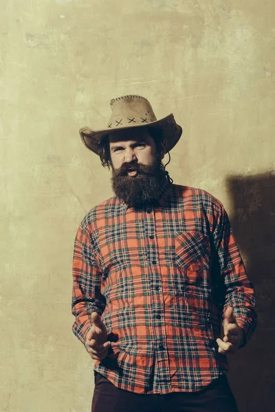 Bearded man with long beard in cowboy hat