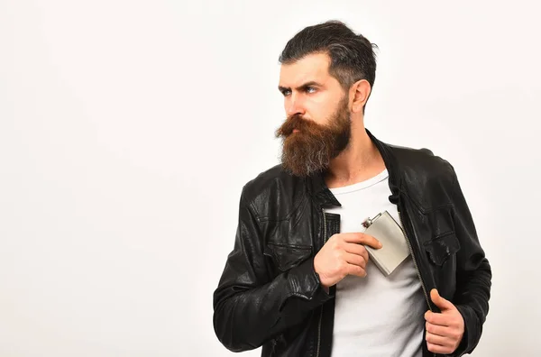 Serious bearded man hipster with metallic jar in leather jacket — Stock Photo, Image