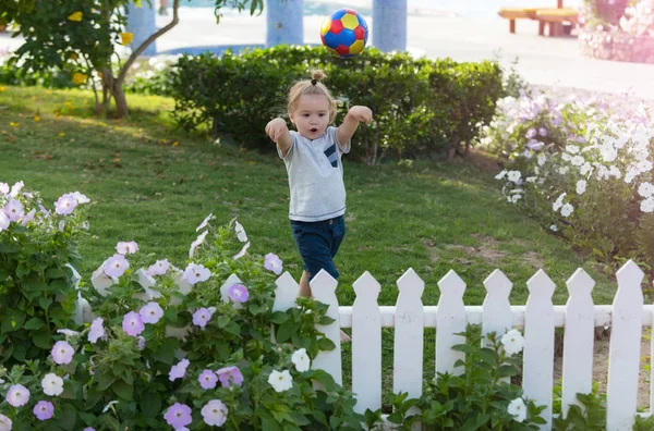 Vzrušený roztomilý šťastný chlapeček házet barevné koule — Stock fotografie