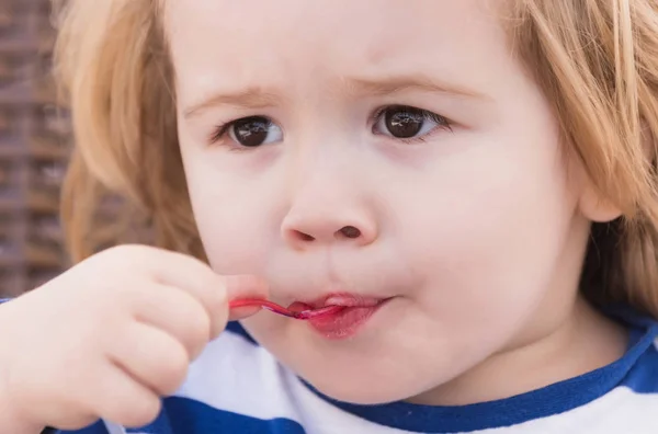 Cute baby boy eating tasty ice cream from spoon — Stock Photo, Image