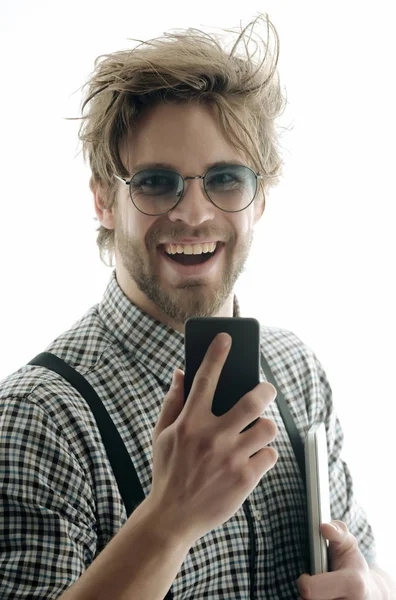 Hombre guapo en gafas con teléfono inteligente y ordenador portátil —  Fotos de Stock