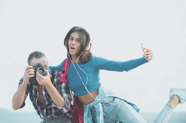 Surprised girl taking selfie with smartphone and photographer photographing — Stock Photo, Image