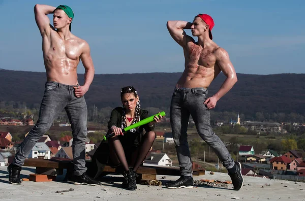 baseball woman and muscular men in cap