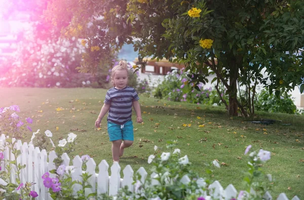 Netter kleiner Junge läuft barfuß auf grünem Gras im Park — Stockfoto