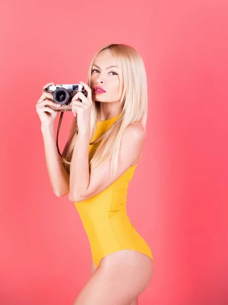 Söt flicka fotograf med retro kamera i gula bodysuit — Stockfoto