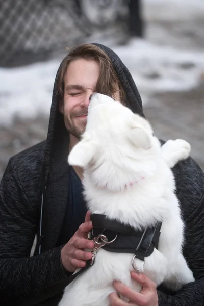 Roztomilý pejsek olizuje tvář šťastný psí muže — Stock fotografie