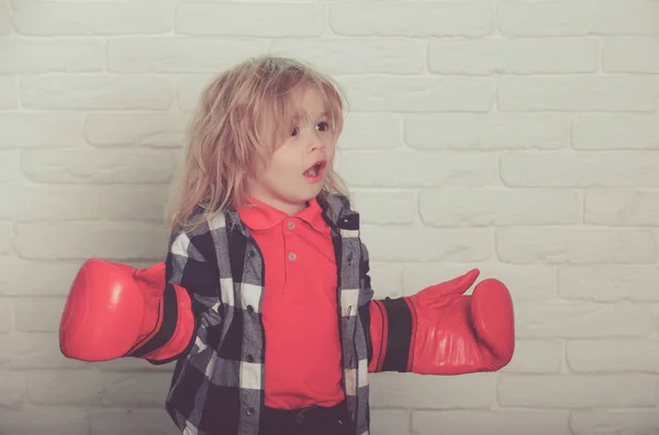 champion or happy small boy in red boxing gloves, winning