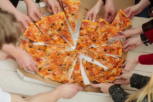 Human hands taking delicious pizza slices from delivery box — Stock Photo, Image