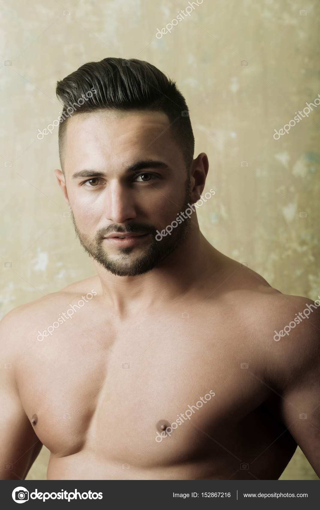 Handsome athletic man showing fit chest Stock Photo by