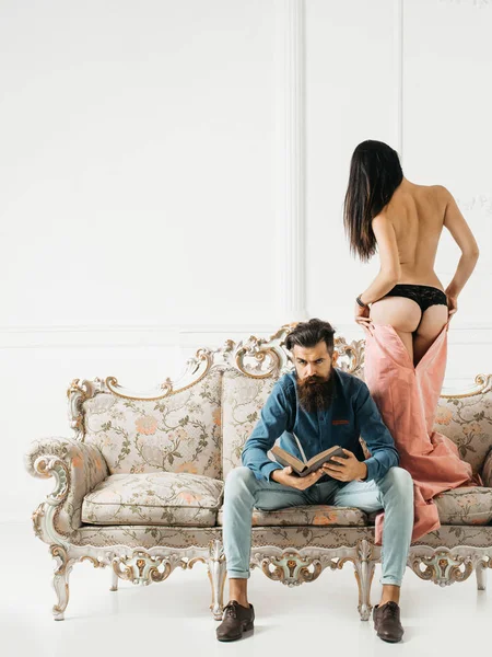 man with sexy woman on couch