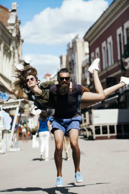 Gülümseyen yakışıklı adam ile şirin kız geri atlama