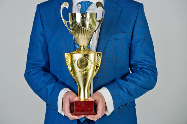 man or businessman with golden champion cup, business success