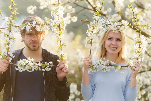 Ζευγάρι στην αγάπη, χαμογελαστή γυναίκα και άντρας στο πλαίσιο λουλουδιών — Φωτογραφία Αρχείου