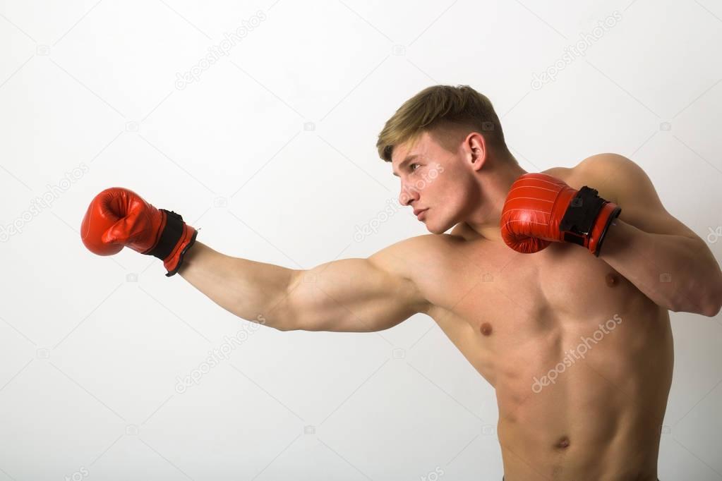 fighter, man boxer, posing in red gloves in boxing stance