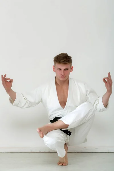 Man, karate fighter sitter i avkopplande yoga position — Stockfoto