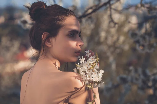 Mädchen mit Haarschopf posiert mit blühenden, weißen Blumen — Stockfoto