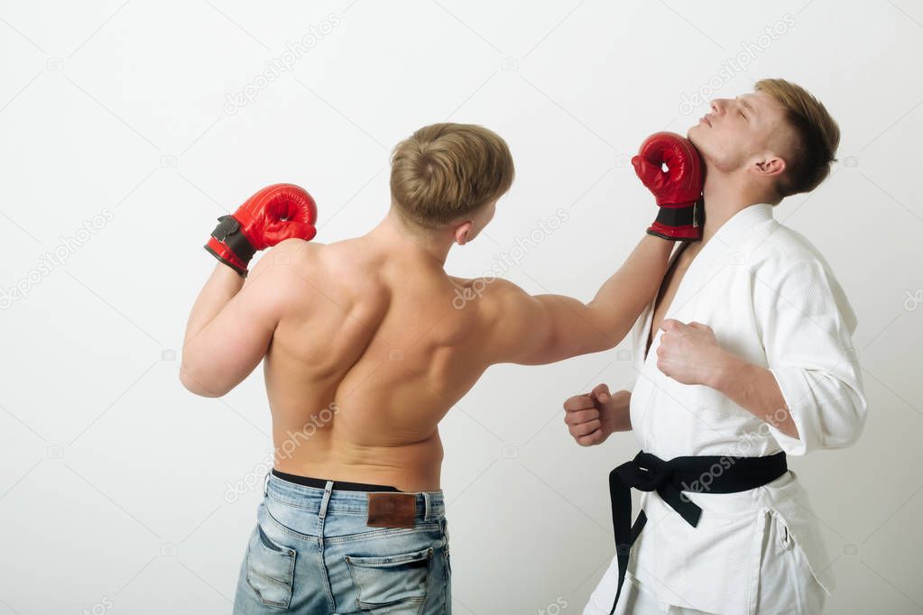 boxer punching young karate athlete