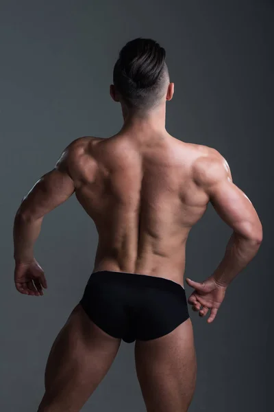Sexy homem com muscular corpo e de volta em cuecas calças — Fotografia de Stock