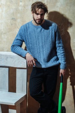 Genç sporcu adam beysbol sopası ile ahşap sandalye, ayakta