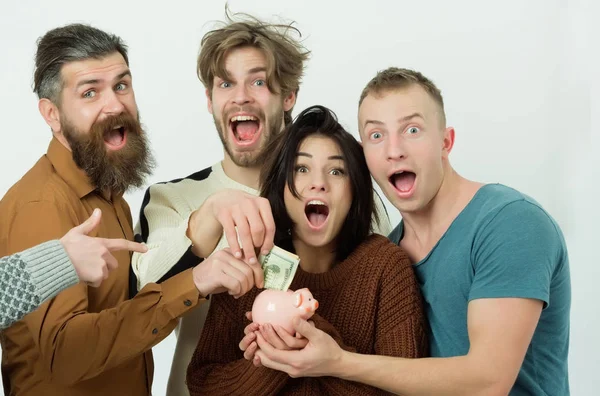 Men and woman putting money in piggy box — Stock Photo, Image