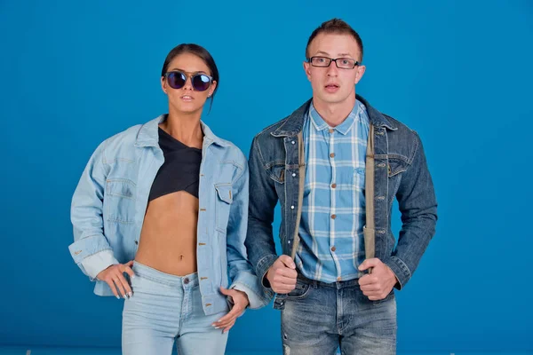 fashionable couple of denim woman and man in glasses