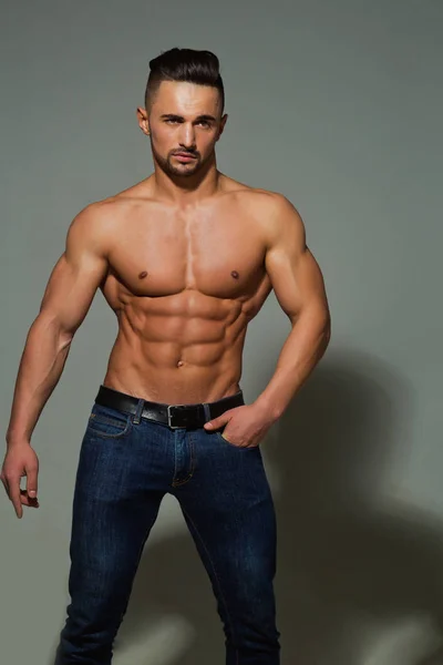 bodybuilder with muscular body in jeans