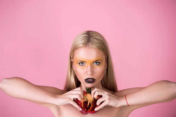 Vrouw houd rode paprika op de roze achtergrond, hart — Stockfoto