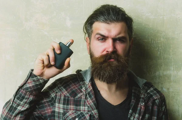 Man posing with black perfume bottle — Stock Photo, Image