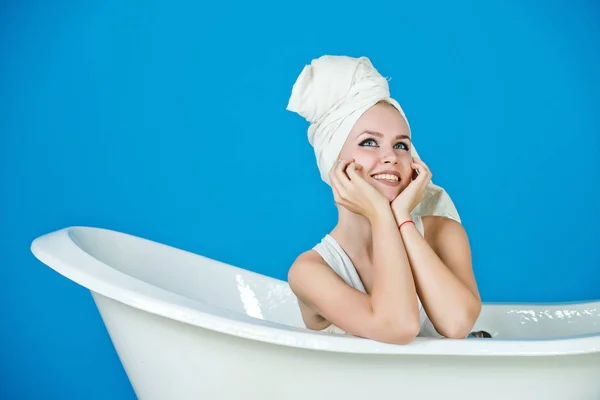 Happy sexy woman with towel turban sitting in white bathtub — Stock Photo, Image