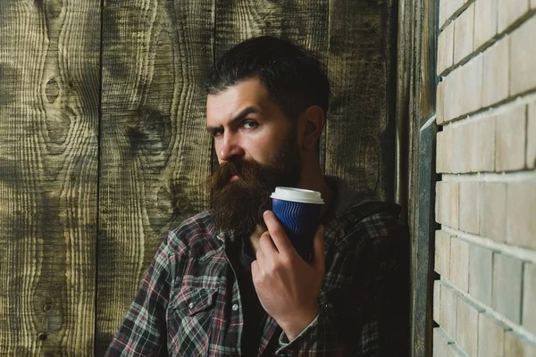 Man standing with blue plastic cup in corner — Stock Photo, Image