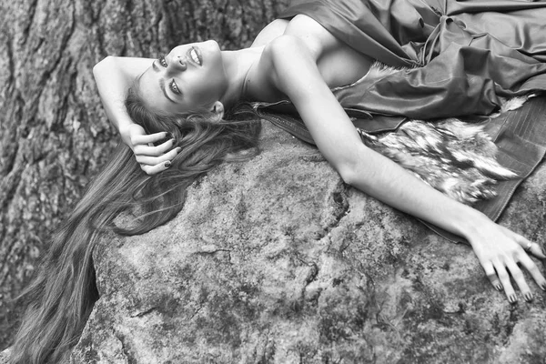 Woman lying on stone