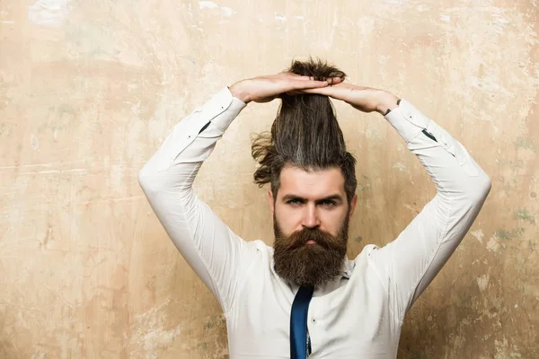 bearded man or hipster with long beard on serious face