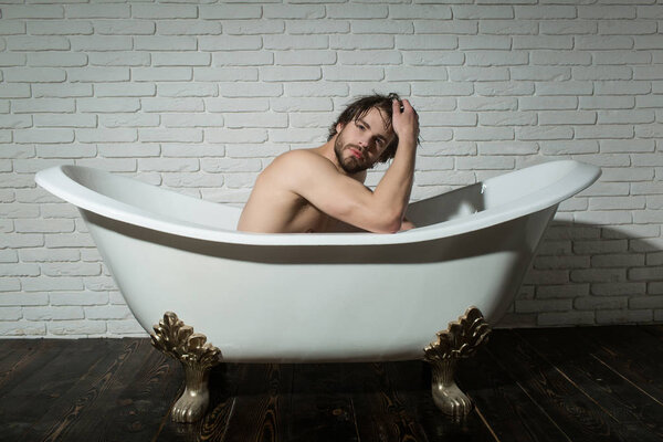 man with muscular body in bath