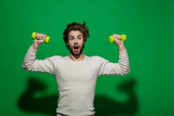 Surprised man with barbell doing morning exercise, has uncombed hair — Stock Photo, Image