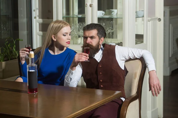 Kız ve adam bir restoranda kırmızı şarap paylaşımı