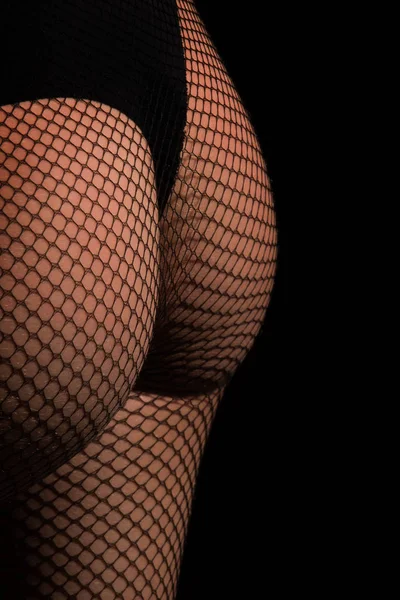 Butt wearing black fishnet pantyhose tights and panties — Stockfoto