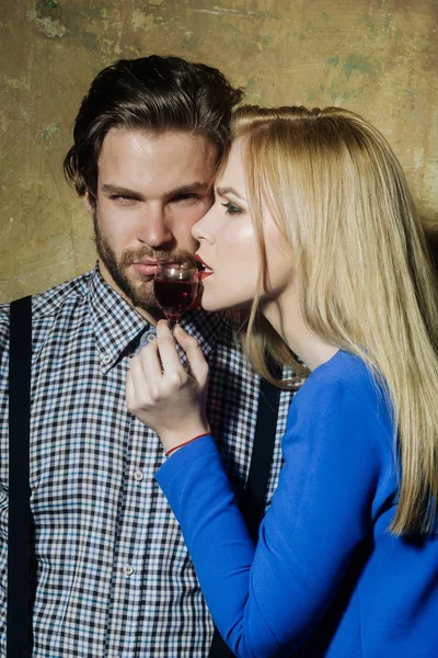 Girlfriend and boyfriend posing with glass of red liqueur