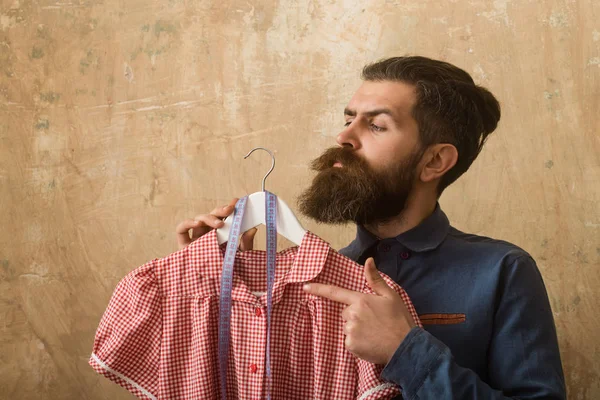 Uomo con barba tenuta vestito e metro a nastro in laboratorio su sfondo beige — Foto Stock