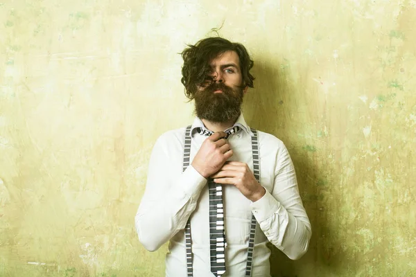 Hipster in shirt and suspenders with musical tie