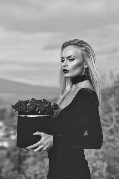 Girl with flowers in box — Stock Photo, Image