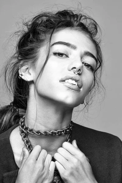woman with metallic chain and nose ring