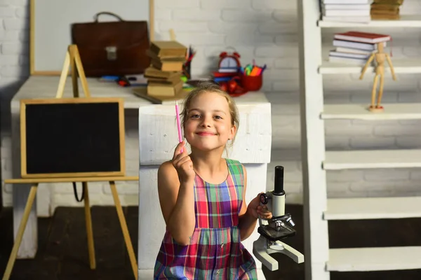 Girl with smiling face in front of school supplies — Stock Photo, Image