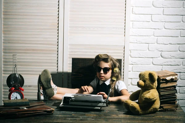 Evrak çantası ve çalar saat ile çocuk.