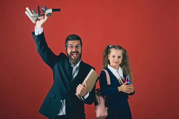 Вчителька і школярка з щасливими обличчями на теракотовому фоні — стокове фото