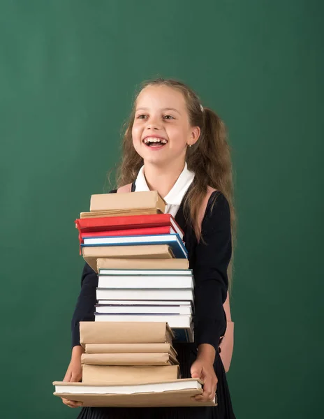 Girl in classroom on green background. Schoolgirl with cheerful face — Stock Photo, Image