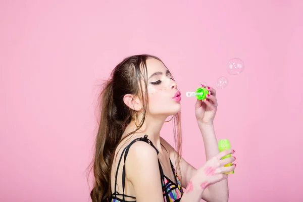 Woman with bubble blower on pink studio background — Stock Photo, Image