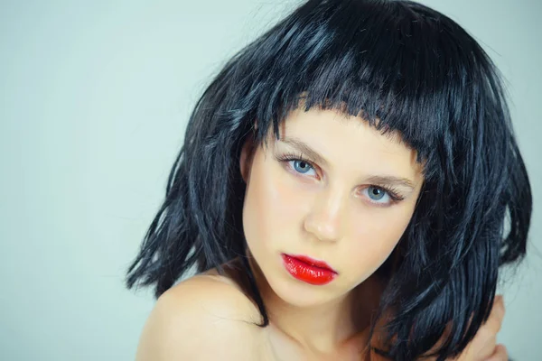 Woman with red lips on face posing in black wig — Stock Photo, Image